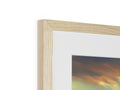 A picture frame containing wooden items in a room with a picture of the sky in it