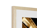 A picture frame on a table holds a picture in an assortment of wood frames.