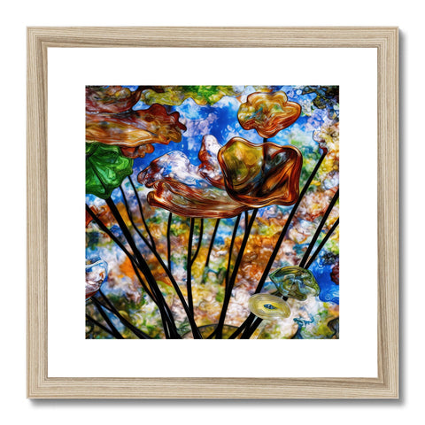 An art print of a cornucopia sitting in a wood frame in an empty wall