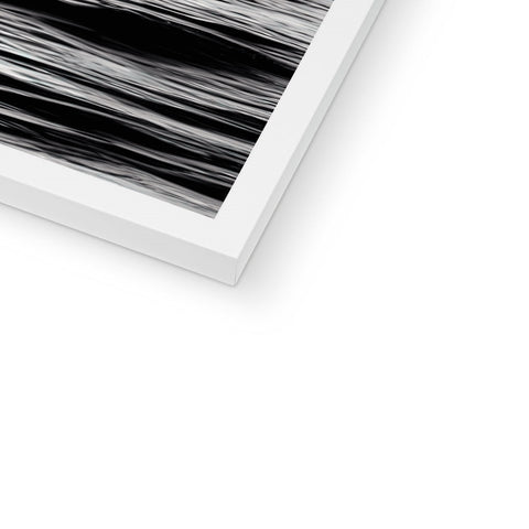 A white picture of a black and white table top with a photograph that looks very abstract