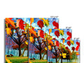 Vintage greeting cards with fall foliage on table with a colorful picture of several trees.