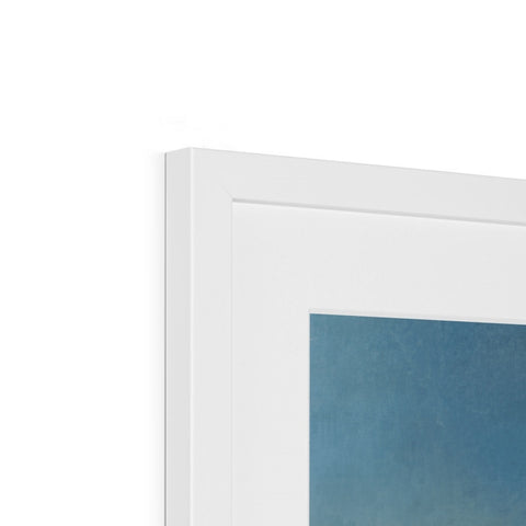 An image of a picture frame mounted in a white frame on a wall.