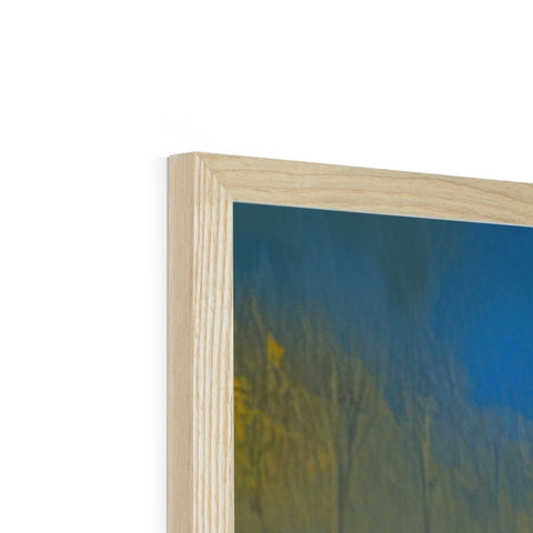 A white wood frame sitting next to a picture frame with a blue background.