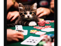 A kitten sitting on the side of a table holding a poker card.