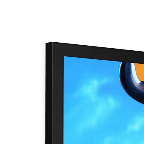 A television is sitting in front of a wall mounted monitor next to an orange television.