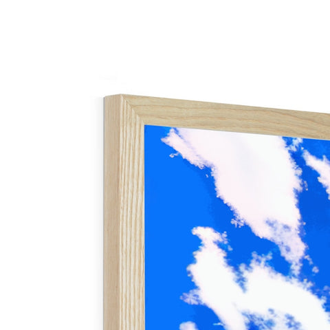 a picture frame made of wood, with a blue sky surrounded by blue sky and clouds