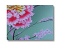 An art print of pink flowers on a blue wall.