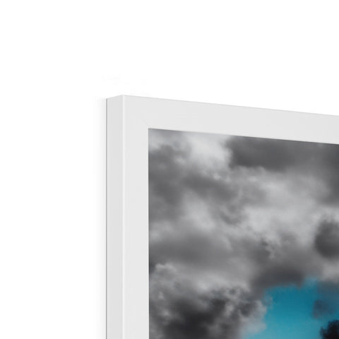 a picture frame with a blue sky in a room with clouds