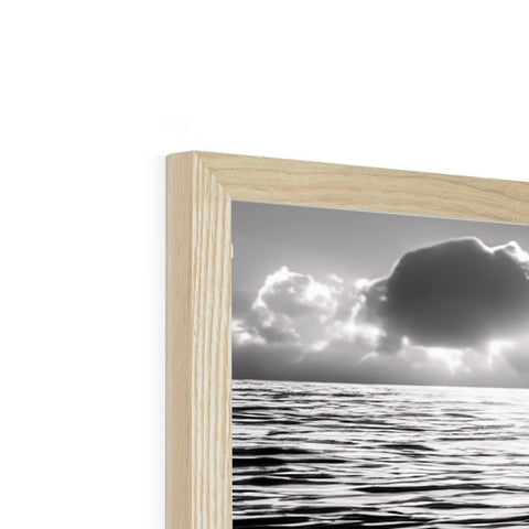 A photo frame with a frame with clouds on it surrounded by a wooden frame.