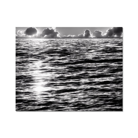 A black and white image of a greenish ocean in the backdrop of ocean water.