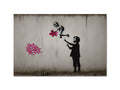 A graffiti spray print with a pink flower and a flower sticking to a wall on a