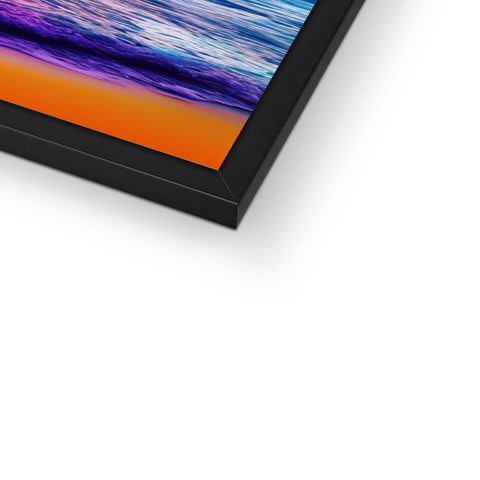 A photo of a flat screen in some sort of a colorful picture frame on a wall