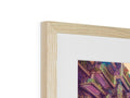 A white photo is pinned to a frame framed in wood