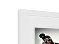 There is a picture of a man with red teeth on a photo in a frames.