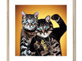 A picture of two cats on an art print with a gold background.