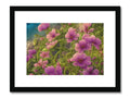 Art print of purple flowers on a cardboard covered in pink flowers.