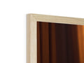 A close up of a wooden headboard with a light colored wood frame.