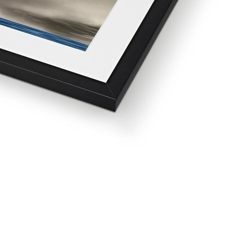 A small picture of an abstract photo in a frame next to a wall top.