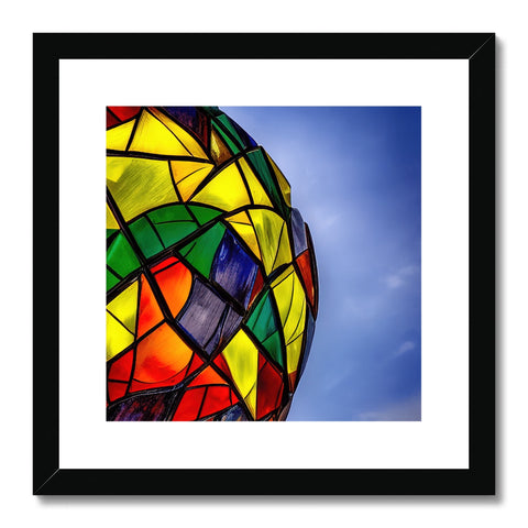 a beautiful framed photo of a kite next to a white glass light box under a