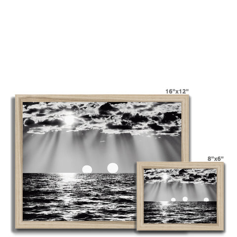 A black and white picture frame with an image of the sun surrounded by two white lines