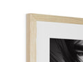 a tall wooden picture frame with a white and black photo on it holding a white piece