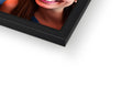 A picture frame of a photo of a smiling woman in a mirror next to a painting