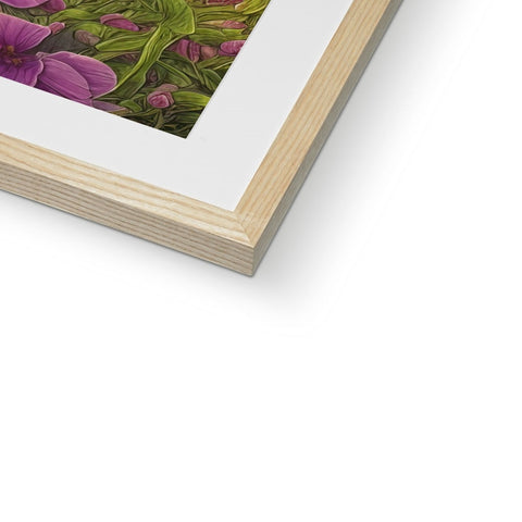 A picture frame sits on top of a wood frame with an art print on it.