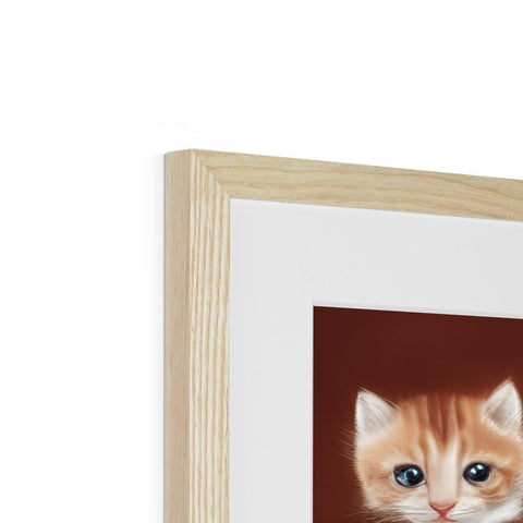 There is a cat looking up in a picture in a wooden photo frame on a wall