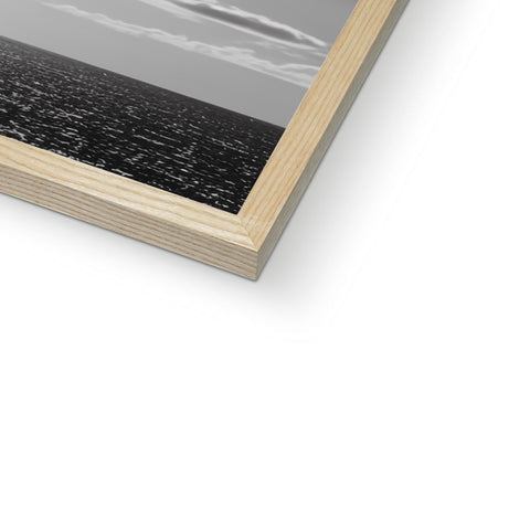 A picture frame from a photo book sitting on top of a wooden desk.