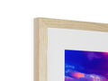 A picture of a red and blue sunset on a wood framed picture