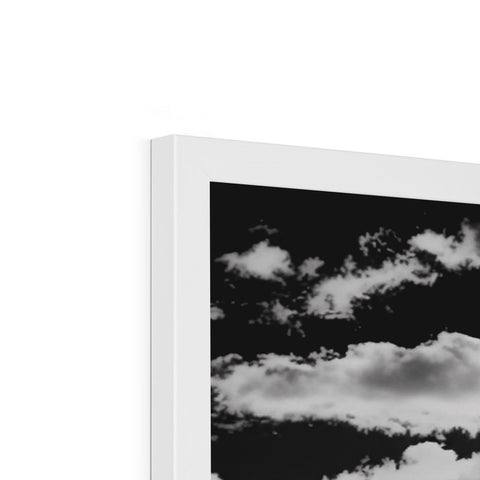A picture frame is displayed on a white background with a picture of clouds.