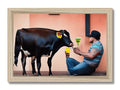 an art print depicting a cow drinking from a trough next to a mirror