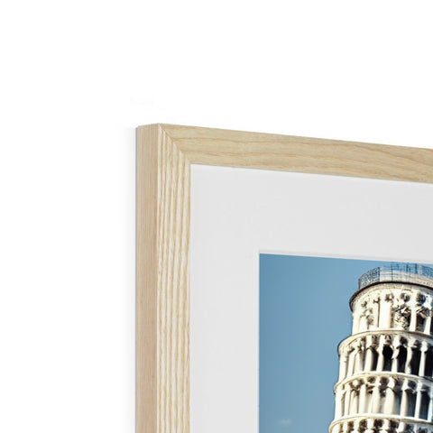 A picture frame with a tall pisa standing over a wooden table.