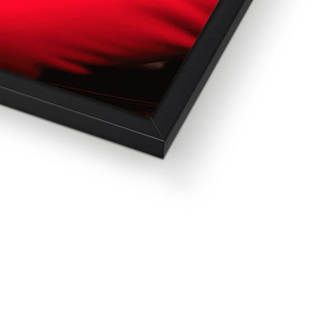 A red photo displayed on top of a picture frame on a white wall.