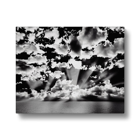 Black and white art print on black paper with sky over the blue ocean.