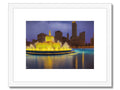 Black and yellow art print of city skyline with buildings sitting on a water surface.