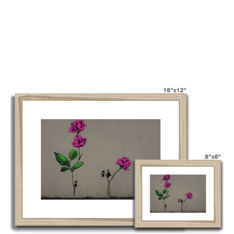 A wooden framed picture with a painting, a watercolor print photo and flowers next to