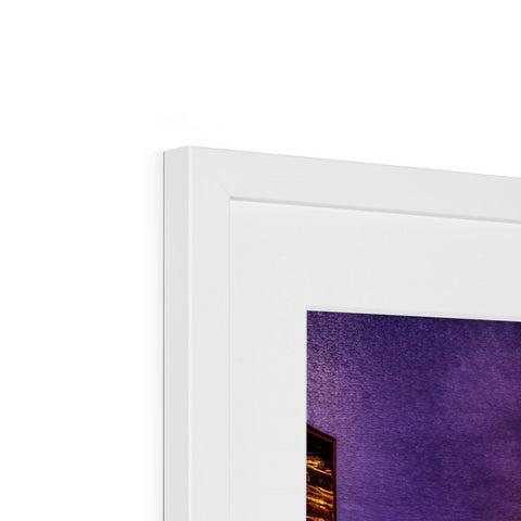 A picture of a picture on a white book top covered by a white frame.