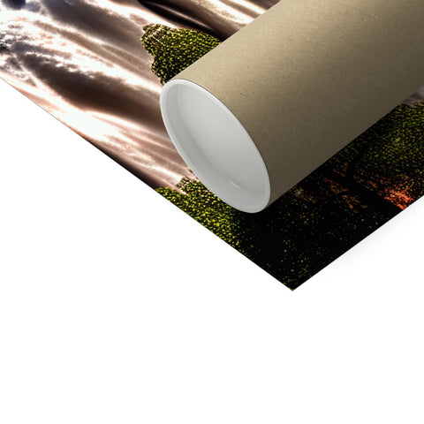 A brown paper roll with green foil printed paper on it is lying on a table.