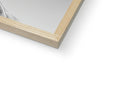 A picture frame sits on top of a window for framing in a wooden frame.