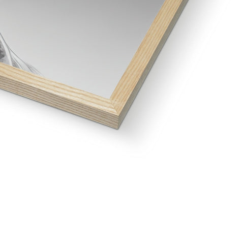 A picture frame sits on top of a window for framing in a wooden frame.