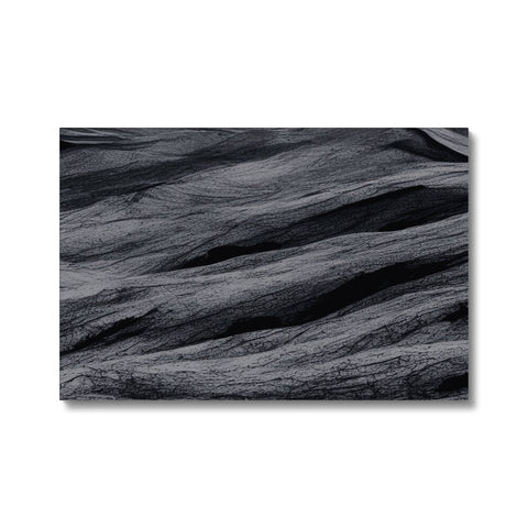 A picture of black and white rocks on a flat desert landscape.