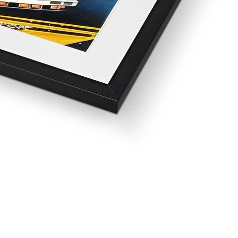a small framed photo sits on top of a black frame sitting on a white frame