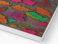 A blanket on top of a wooden table with colorful paper.