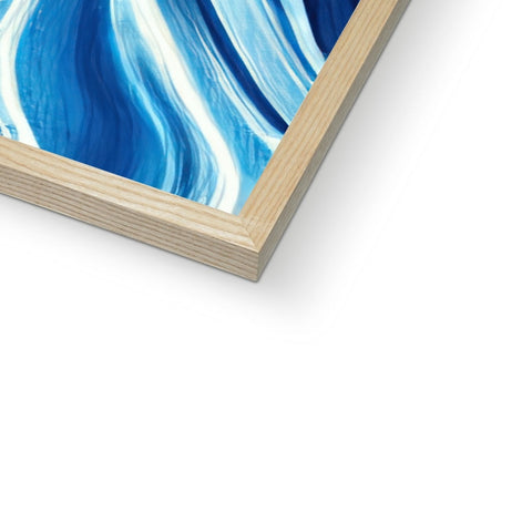 A glass framed picture of the ocean sitting on top of a wood panel in a frame