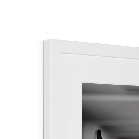 A white counter under a black and white picture frame.