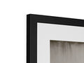A picture frame in white with black paint hanging high in the room.