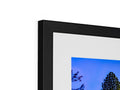 A picture frame sitting on top of a large display screen that is shown as background.