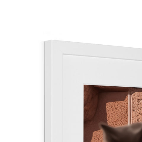 A cat is hiding in the opening of a window frame in some brick wall.