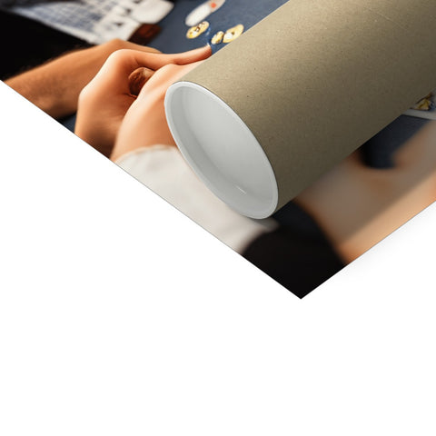 A large trifold wrapped topper roll next to a stack of paper.